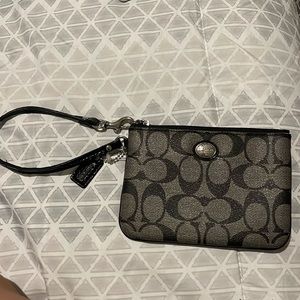 Coach Wristlet (a part of the strap is peeling)
